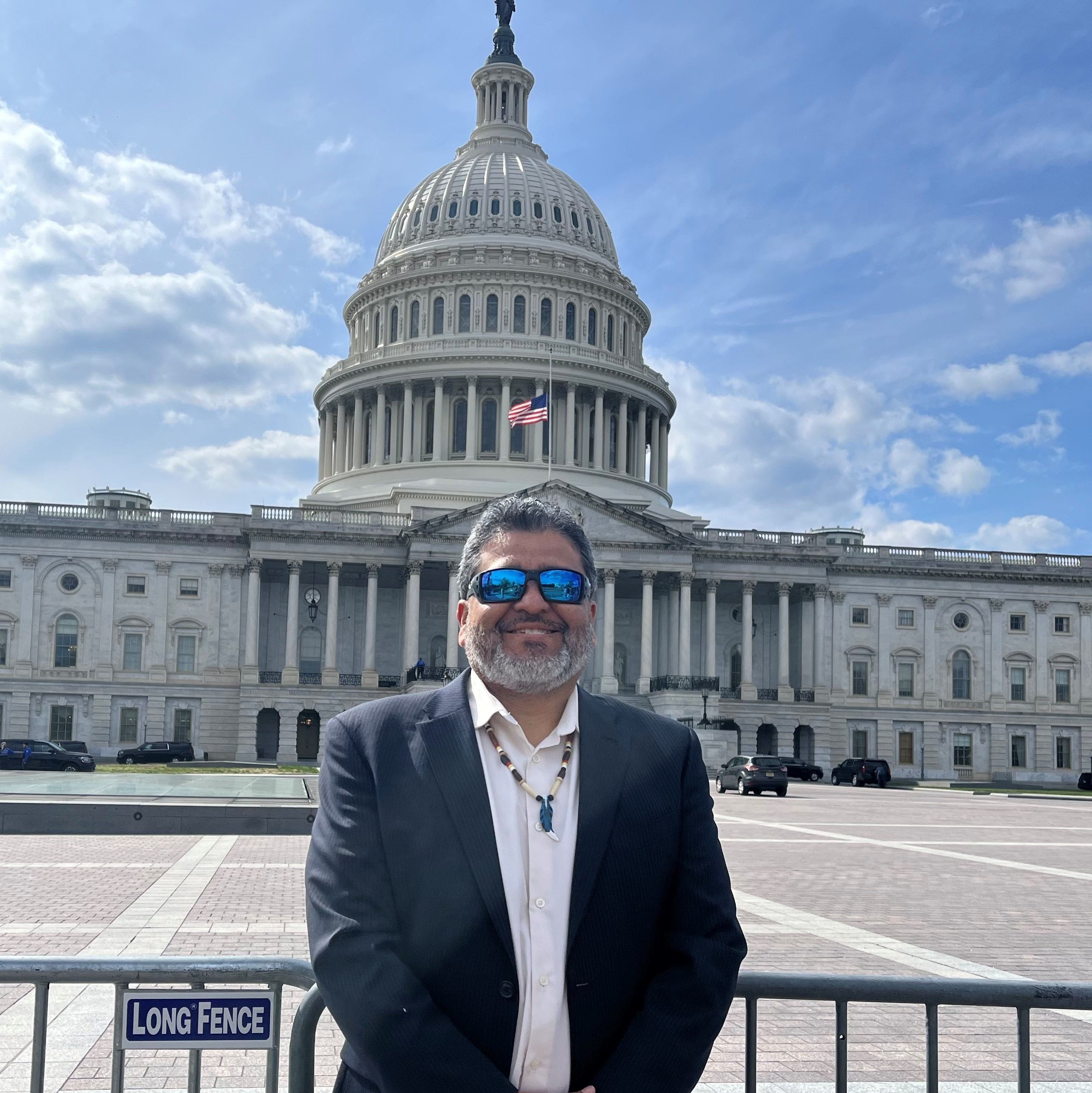Gilbert in Washington, D.C. with the U.S. Capitol behind him